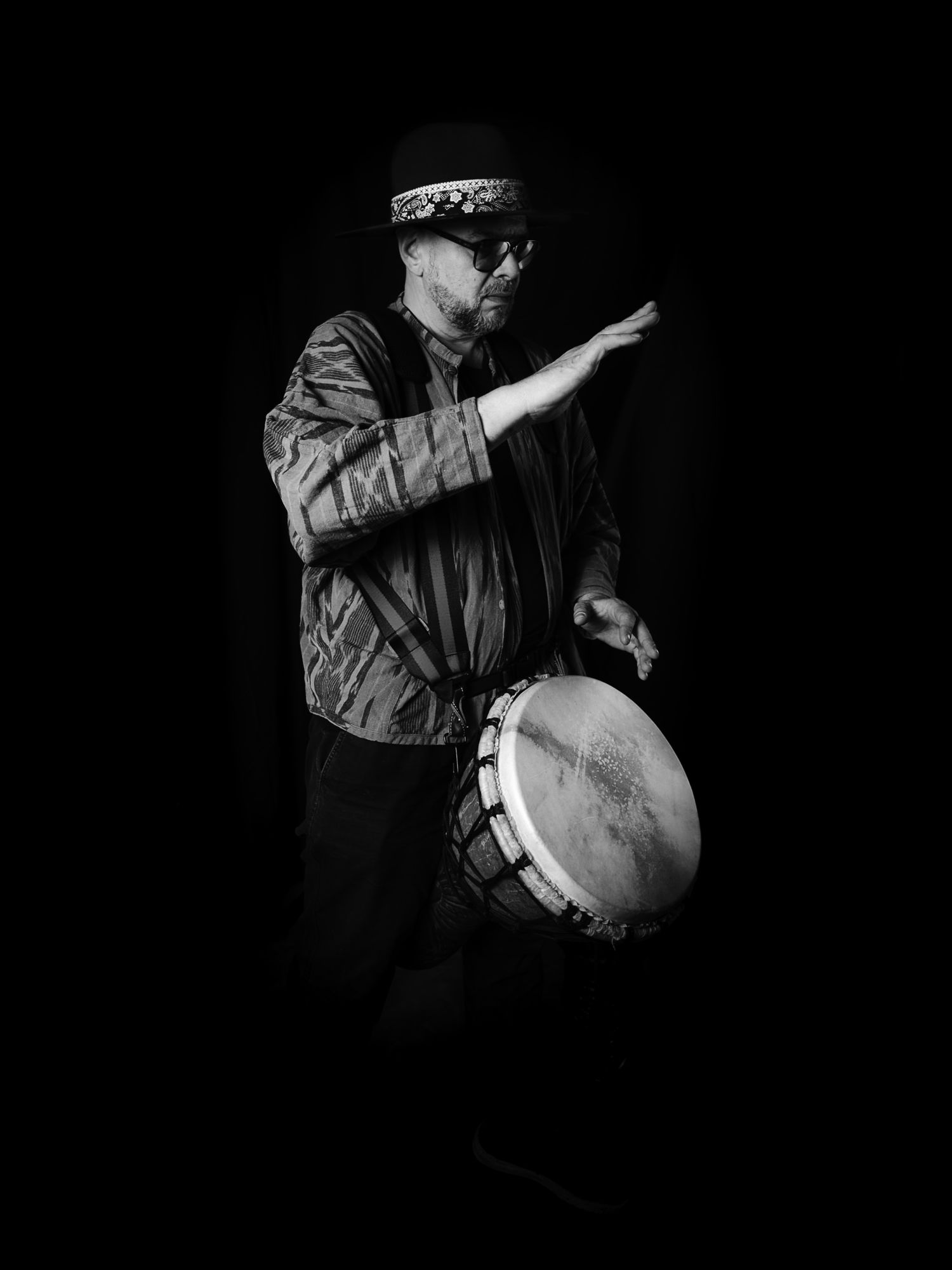 Master M mid-gesture with djembé
