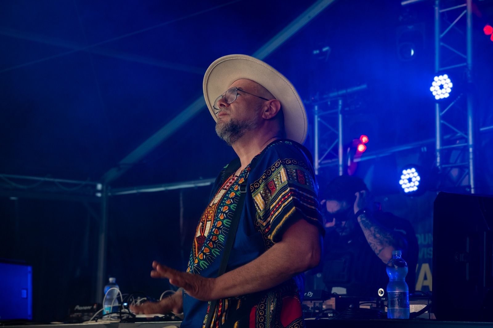 Master M on stage under blue light